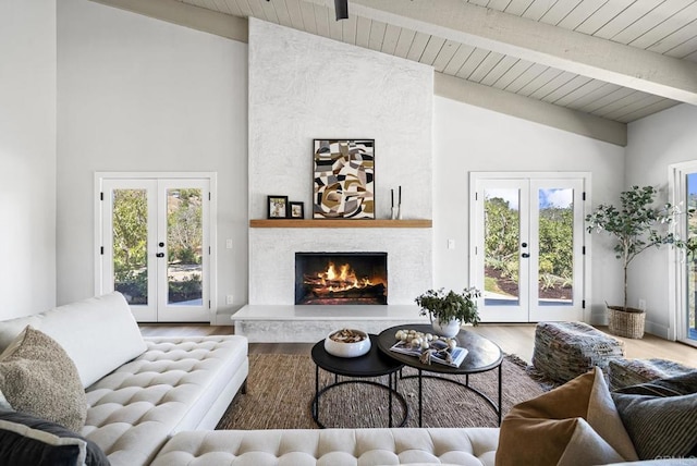 living room featuring hardwood / wood-style flooring, french doors, and a fireplace