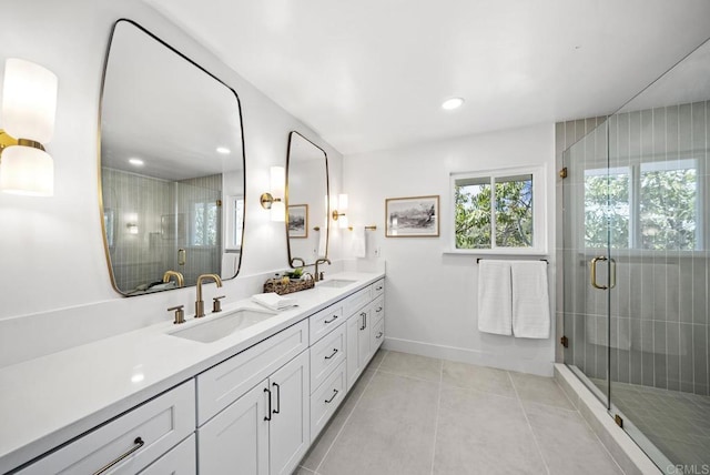 bathroom featuring a shower with door and vanity