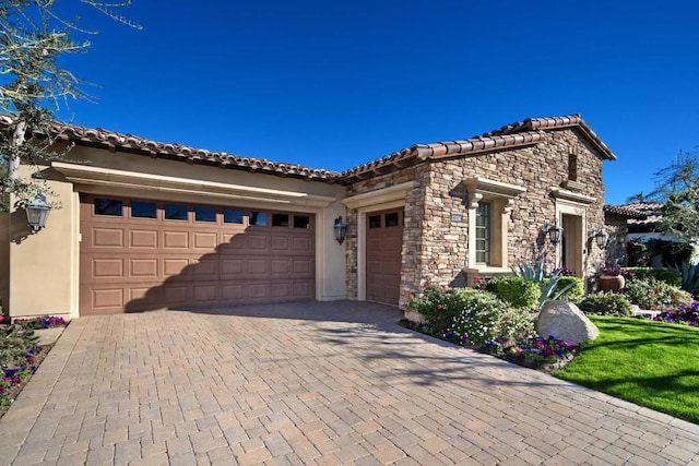 mediterranean / spanish house featuring a garage