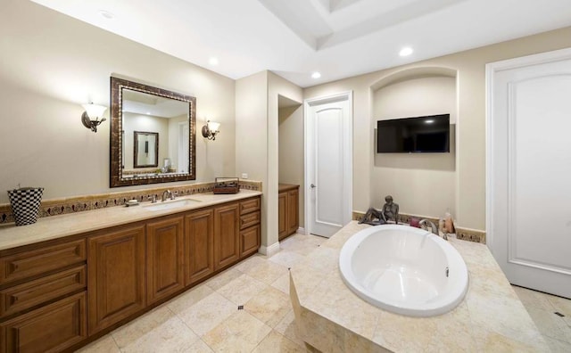 bathroom with vanity and a relaxing tiled tub