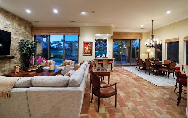 living room featuring crown molding and a notable chandelier