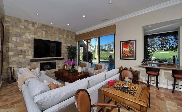 living room featuring a stone fireplace and ornamental molding