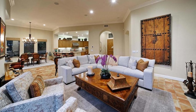 living room featuring ornamental molding and an inviting chandelier