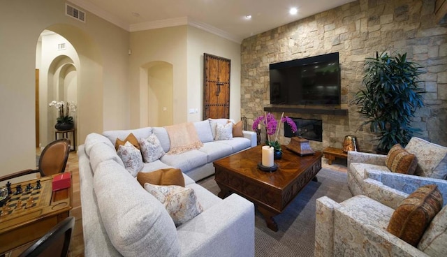 living room with a fireplace and ornamental molding