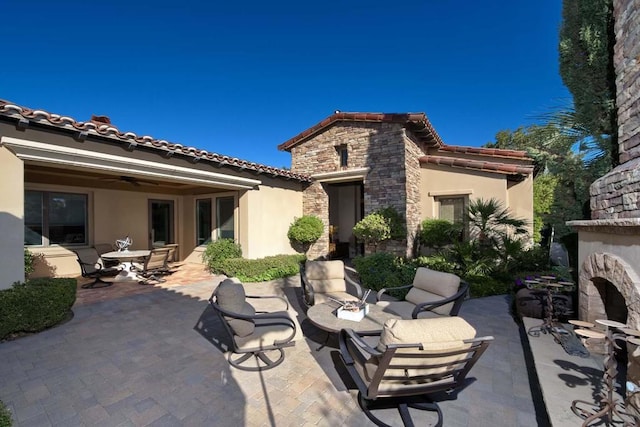 exterior space featuring ceiling fan and a patio area