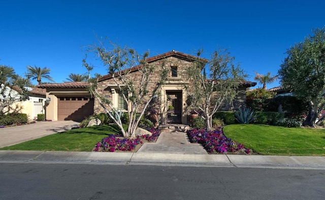 mediterranean / spanish house with a garage and a front yard