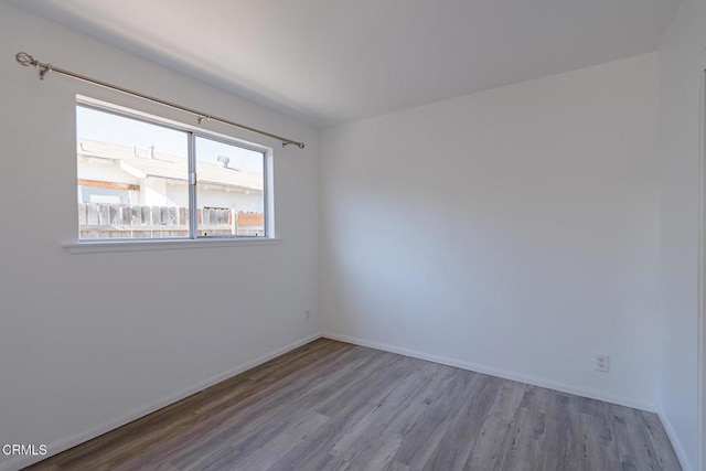 spare room with light hardwood / wood-style floors