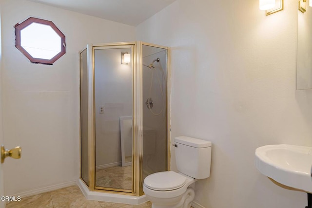 bathroom with tile patterned floors, sink, a shower with door, and toilet