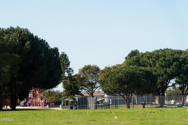 view of home's community with a yard and a playground