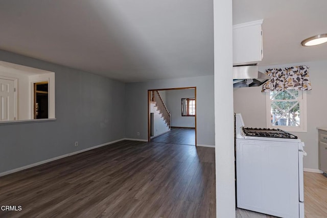 unfurnished living room with dark wood-type flooring