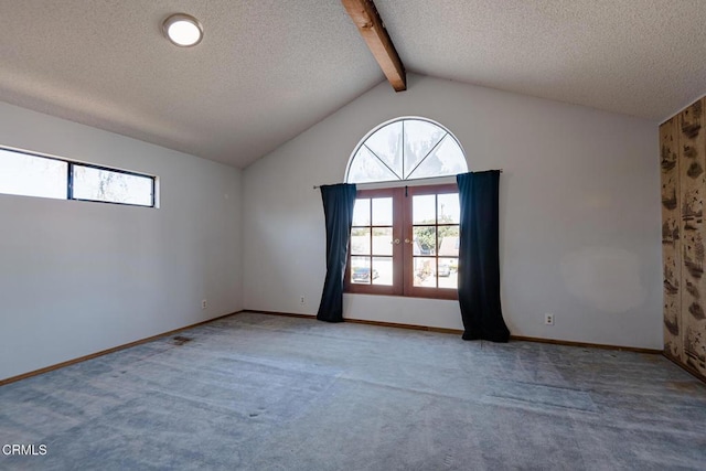 unfurnished room featuring carpet, french doors, lofted ceiling with beams, and a textured ceiling