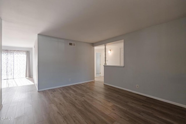 unfurnished room featuring dark hardwood / wood-style floors