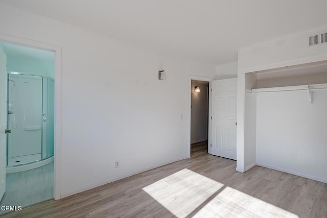 unfurnished bedroom featuring light hardwood / wood-style floors and a closet