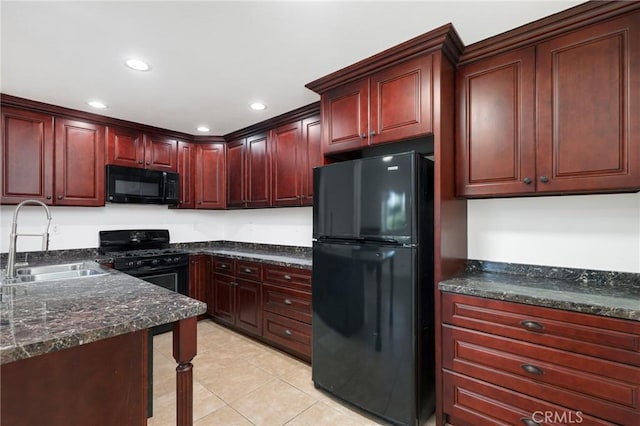 kitchen with black appliances, dark stone countertops, light tile patterned flooring, and sink