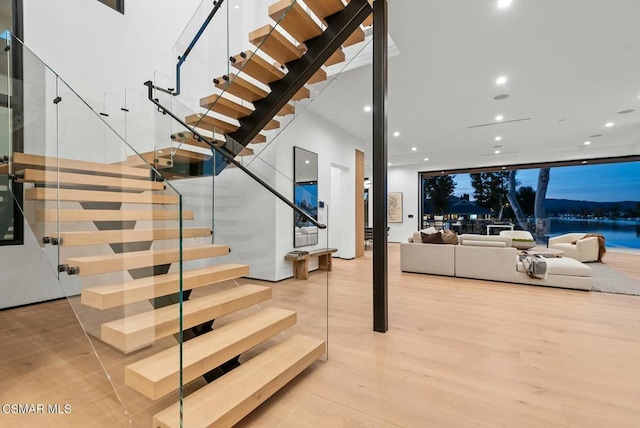 stairs featuring hardwood / wood-style flooring