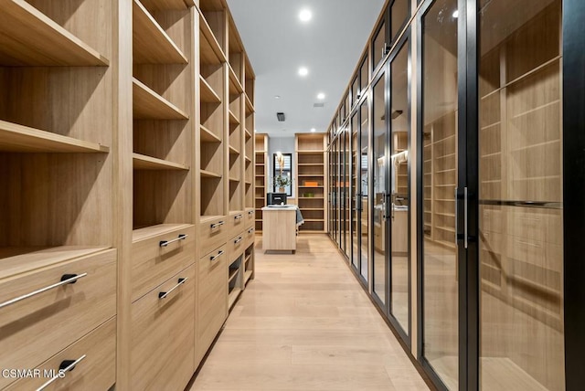 wine area with light hardwood / wood-style floors