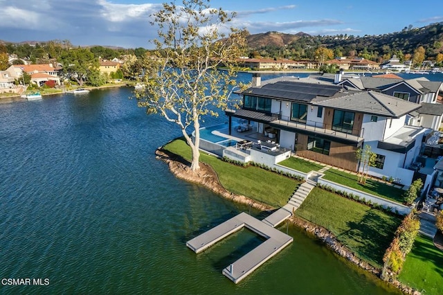 drone / aerial view with a water and mountain view