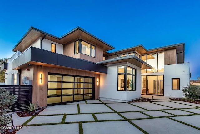 contemporary home featuring a balcony and a garage