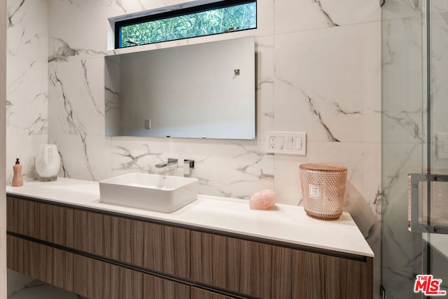 bathroom with vanity, walk in shower, and backsplash