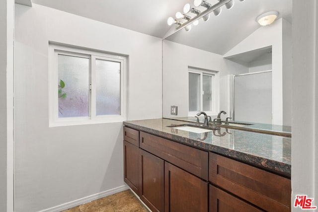 bathroom with vanity and lofted ceiling