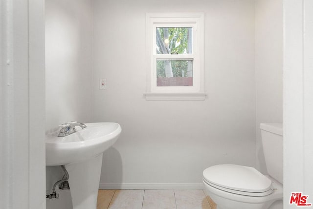 bathroom with toilet and tile patterned flooring