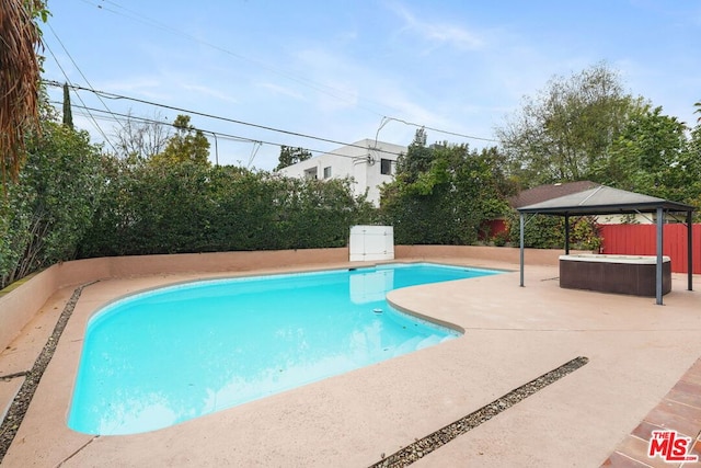 view of swimming pool with a gazebo, a jacuzzi, and a patio area