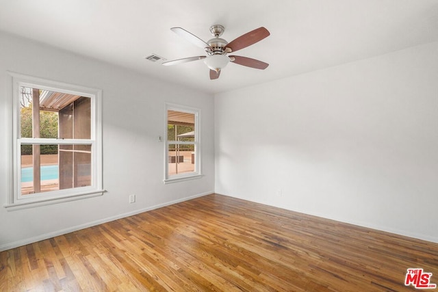 empty room featuring ceiling fan and hardwood / wood-style floors