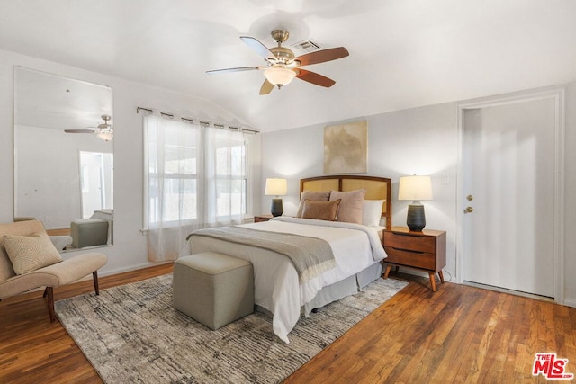 bedroom with vaulted ceiling, ceiling fan, and hardwood / wood-style floors