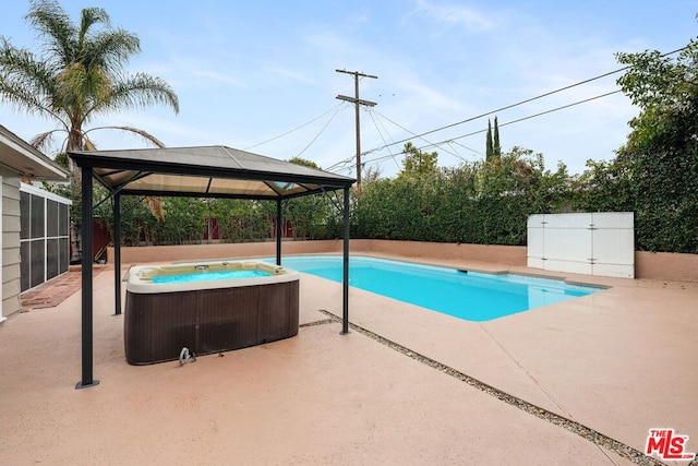 view of pool with a hot tub, a gazebo, central AC, and a patio area