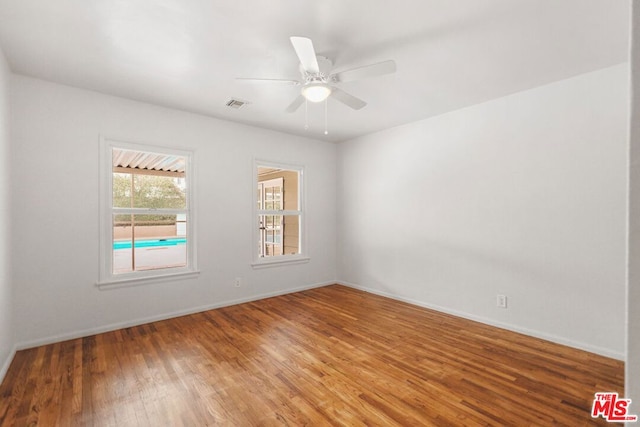 unfurnished room with wood-type flooring and ceiling fan