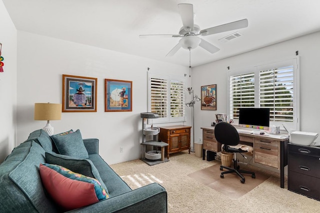 carpeted home office with ceiling fan