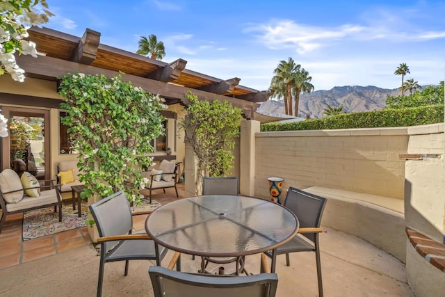 view of patio / terrace featuring an outdoor living space, a mountain view, and a pergola