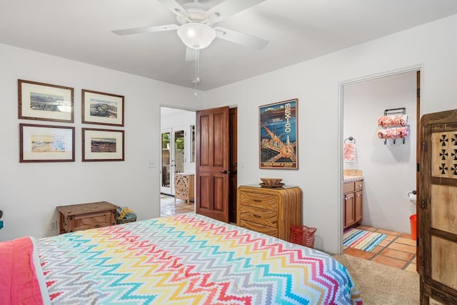 bedroom with connected bathroom, ceiling fan, and light tile patterned flooring