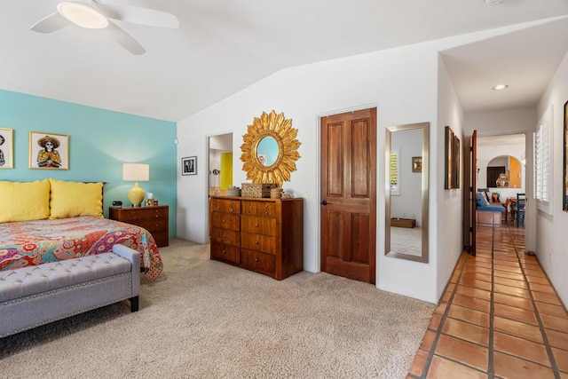 bedroom with light colored carpet, ceiling fan, and lofted ceiling