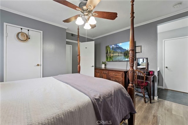 bedroom featuring ornamental molding, ceiling fan, and hardwood / wood-style floors