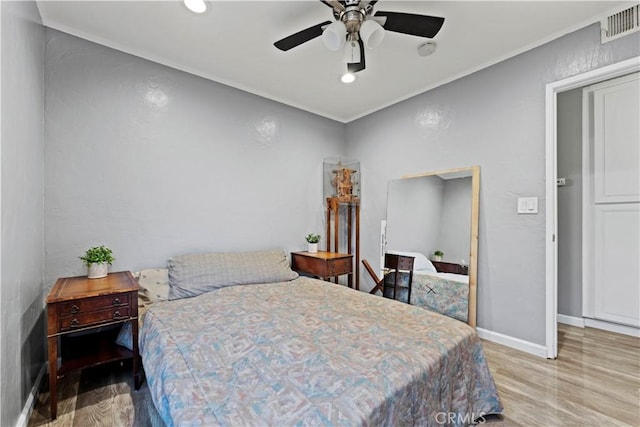 bedroom with light wood-type flooring and ceiling fan