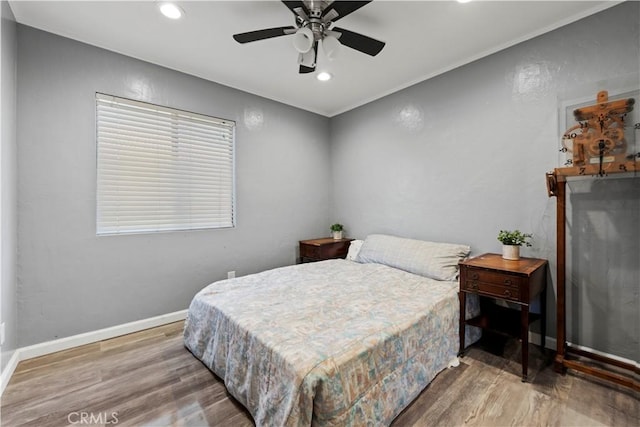 bedroom featuring ceiling fan and hardwood / wood-style flooring