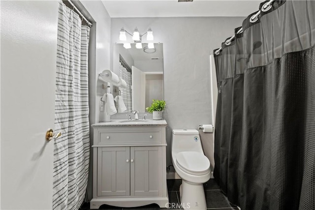 bathroom with toilet, curtained shower, tile patterned floors, and vanity