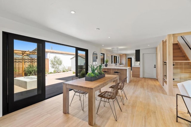 dining space with light hardwood / wood-style floors