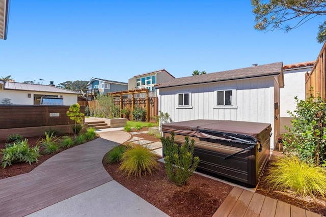 back of house featuring a hot tub