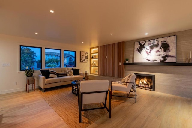 living room featuring a fireplace and light hardwood / wood-style floors