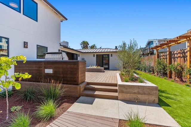 back of property with a wooden deck and a yard