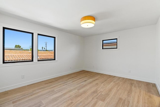 empty room with light hardwood / wood-style flooring