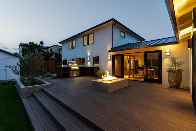 deck at dusk with a fire pit