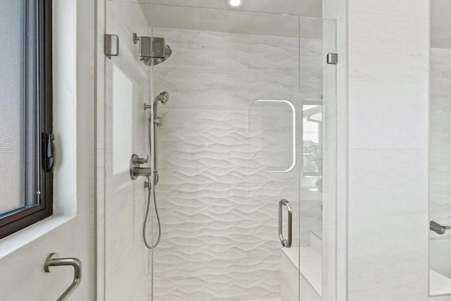 bathroom with a shower with shower door