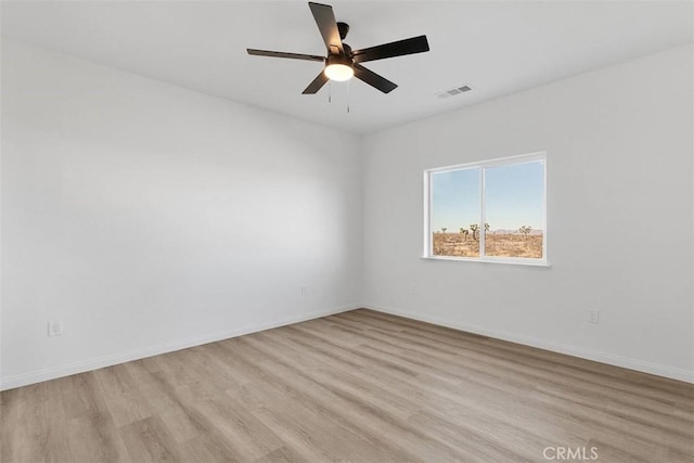 empty room with ceiling fan and light hardwood / wood-style floors