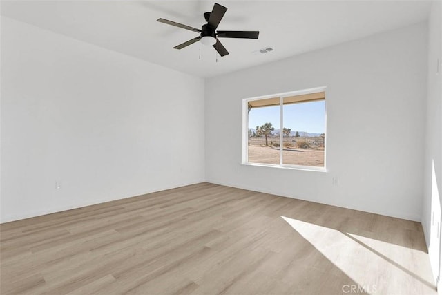 spare room featuring ceiling fan and light hardwood / wood-style floors