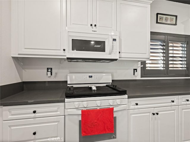 kitchen featuring white cabinetry and white appliances