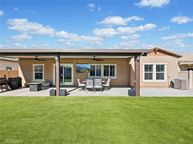 rear view of house with a lawn, ceiling fan, and a patio area