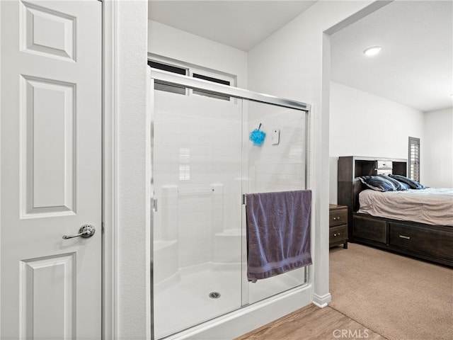 bathroom featuring hardwood / wood-style floors and walk in shower